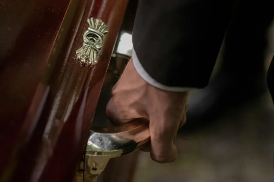 Hand on the handle of a coffin